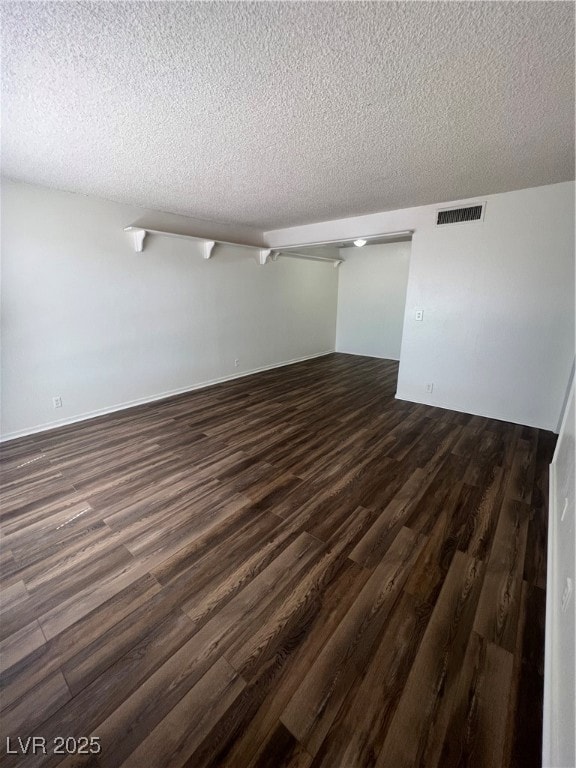 Empty room featuring dark wood finished floors and