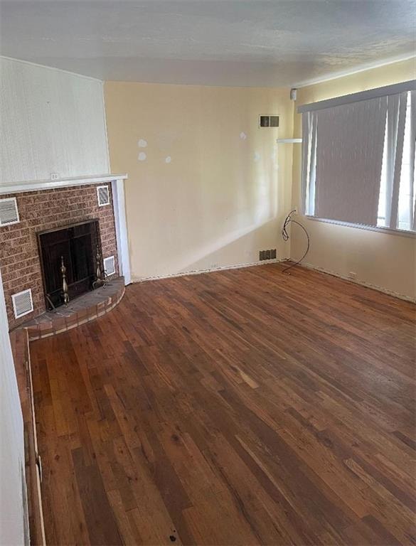 Front Living room with brick fireplace, beautiful hard wood floors.