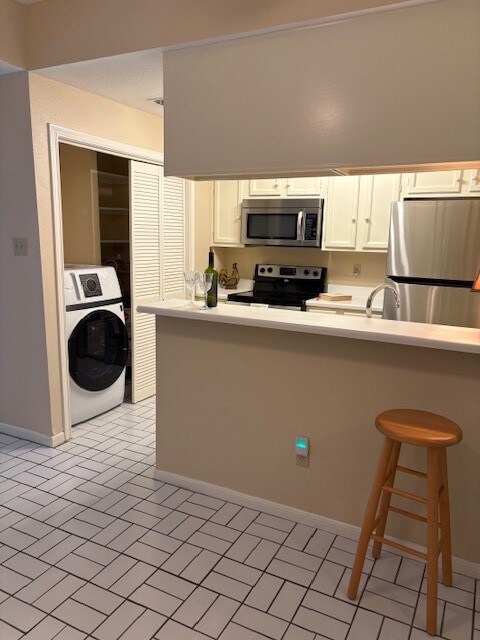 Breakfast Bar with view of kitchen and laundry are