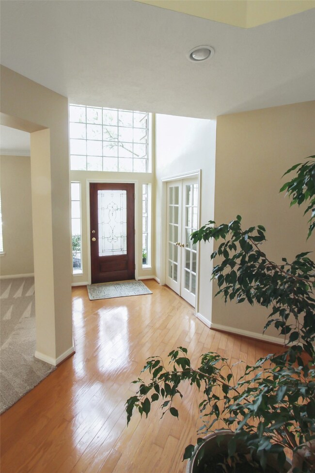 The spacious entry leads to a formal dining room on the right and a home office/study on the left.