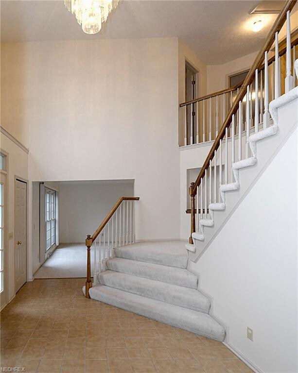 Spacious front foyer with a 17' ceiling and large upper-level window.