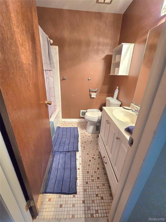 Full bath featuring vanity, shower / tub combination, and light tile patterned floors