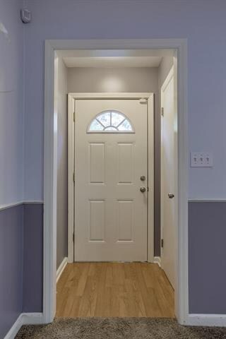 Laminated wood entry and coat closet.