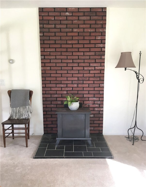 Living room is ready for a wood or pellet burning