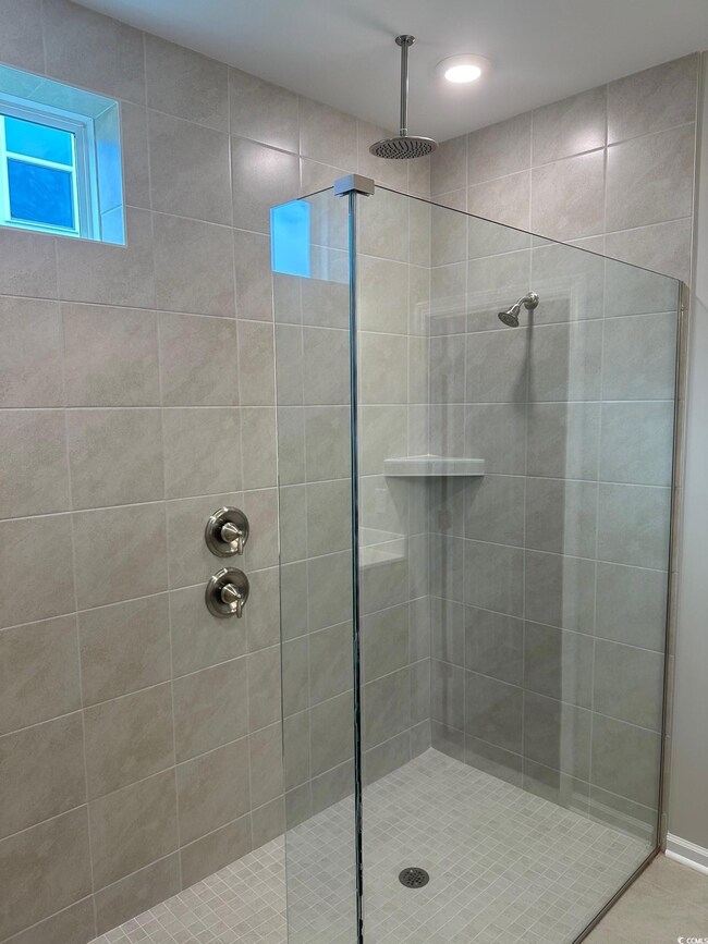 Bathroom featuring tiled shower