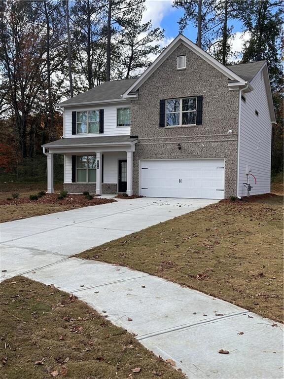 Front porch with brick front home.