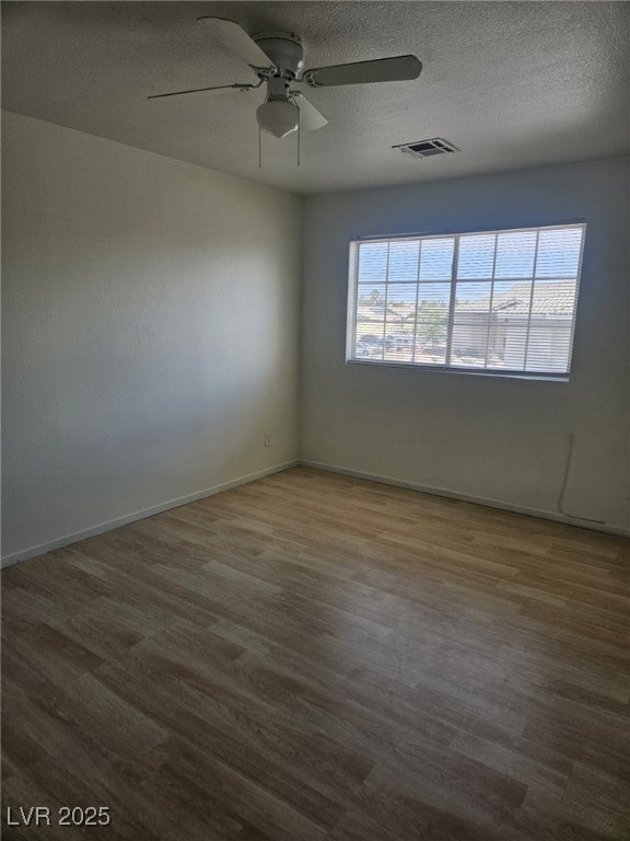 Unfurnished room with a textured ceiling, wood fin