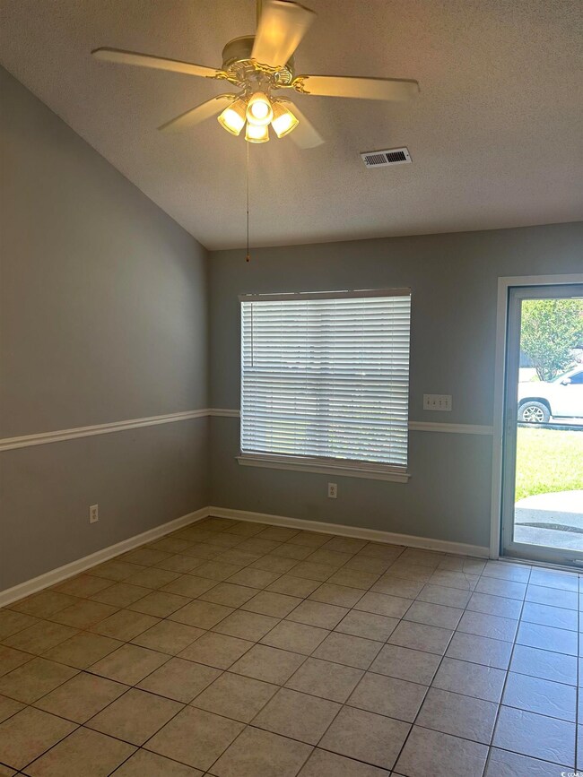 Spare room featuring tile patterned floors, a text