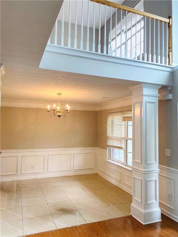 Unfurnished room featuring crown molding, decorati
