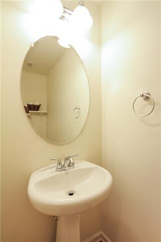 Downstairs half bath - located in a hallway just off the living room. 