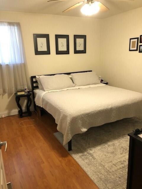 CLEAN AND SPACIOUS BEDROOM WITH WOOD LAMINATE FLOORS/