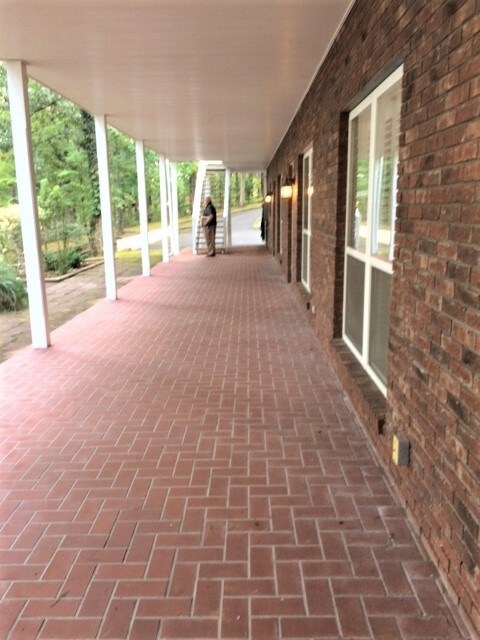 The covered brick patio adds additional space for 