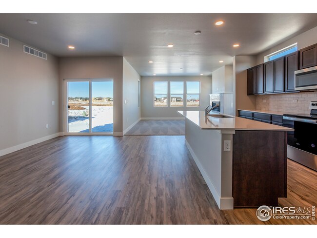 KITCHEN OPEN TO DINING ROOM AND LIVING ROOM