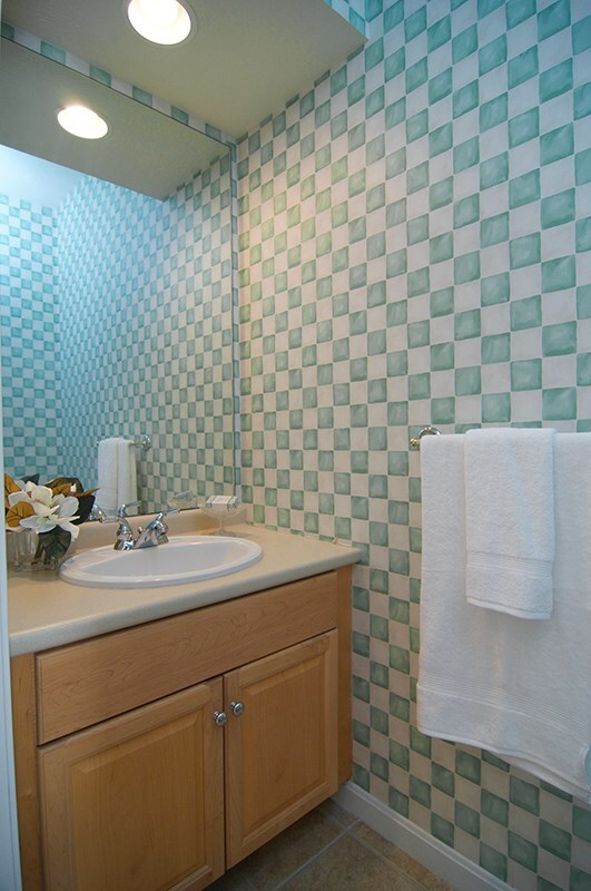Spacious powder room off the foyer. Designer style