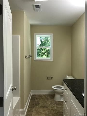 Master ensuite with white shaker cabinets and gran