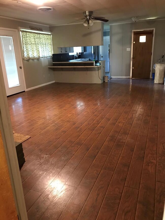 hallway looking through living room to kitchen