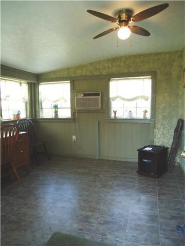 The dining room is convenient to the kitchen, has a french door leading to it and an exterior door to the deck.