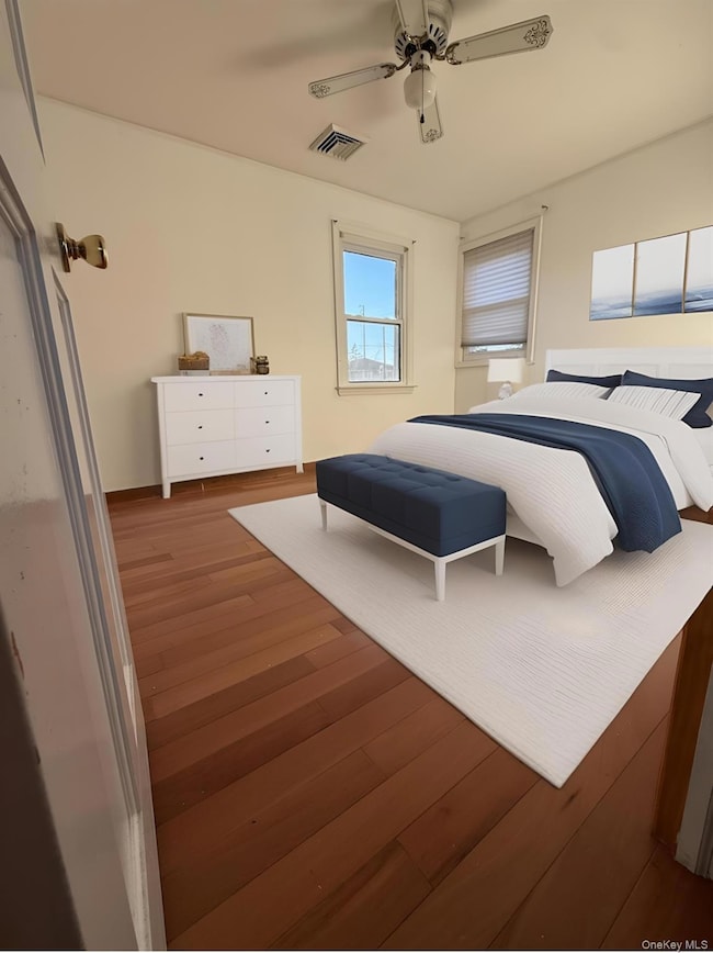 Bedroom featuring wood finished floors and a ceiling fan