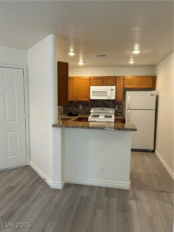 Kitchen featuring refrigerator, white gas stove, w