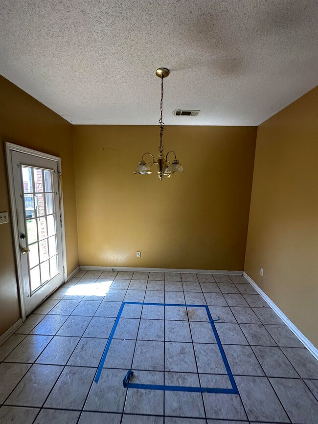 Unfurnished dining area featuring baseboards, an i