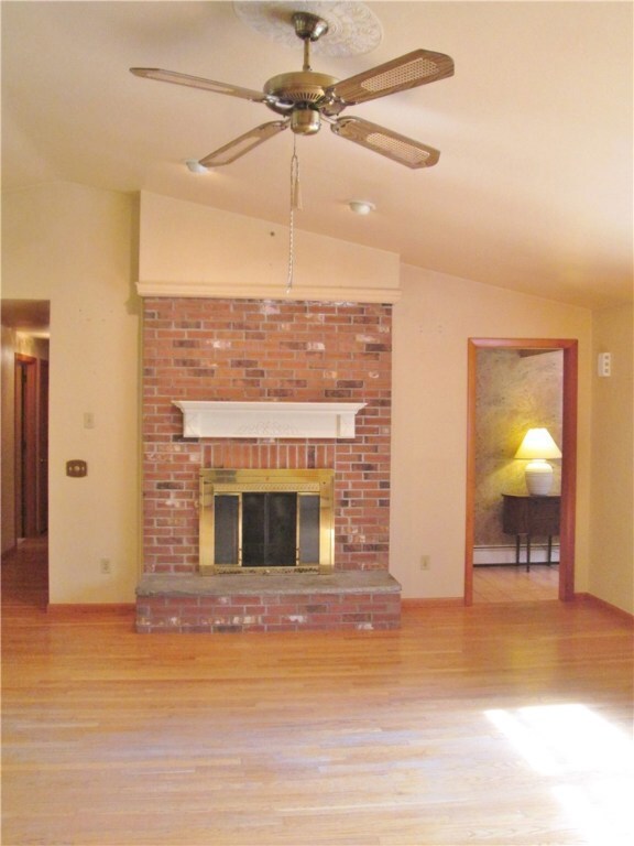 The main living area boasts hardwood floors, cathe