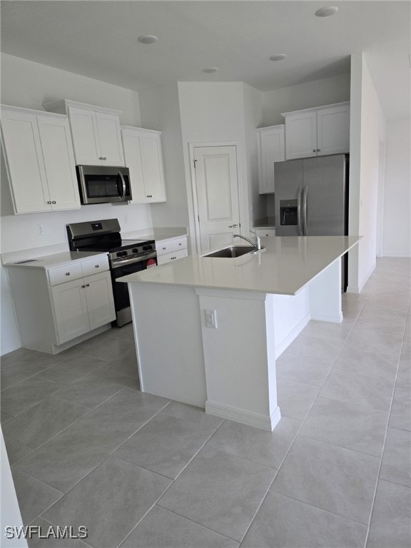Kitchen featuring a sink, white cabinets, a center