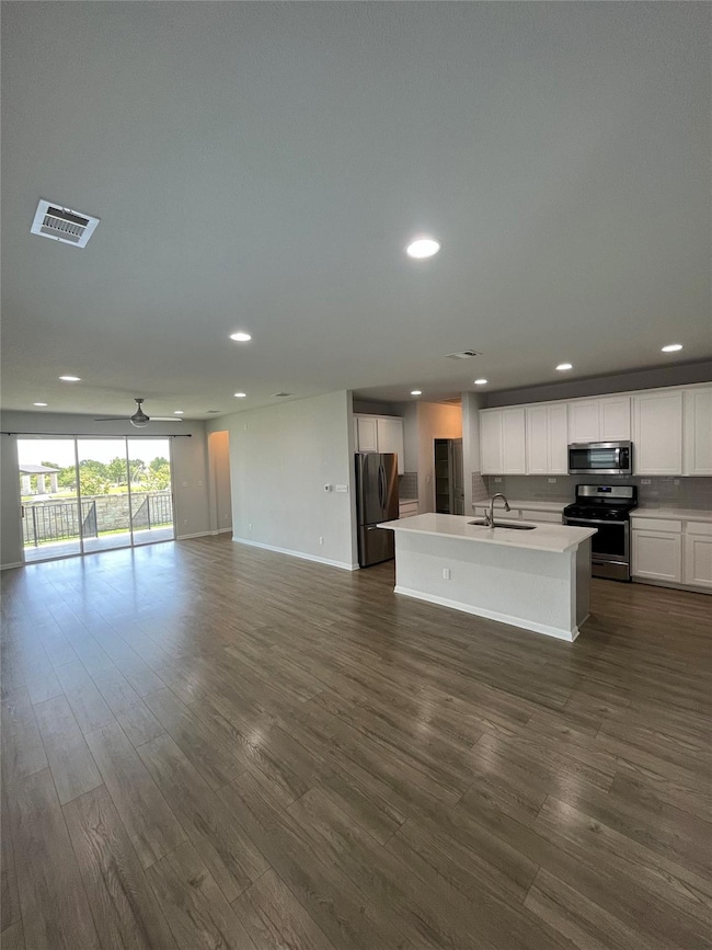 Kitchen featuring open floor plan, appliances wit