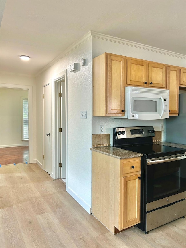 Kitchen featuring stainless steel electric stove,