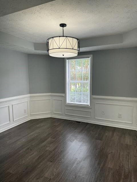 Unfurnished dining area featuring a textured ceili