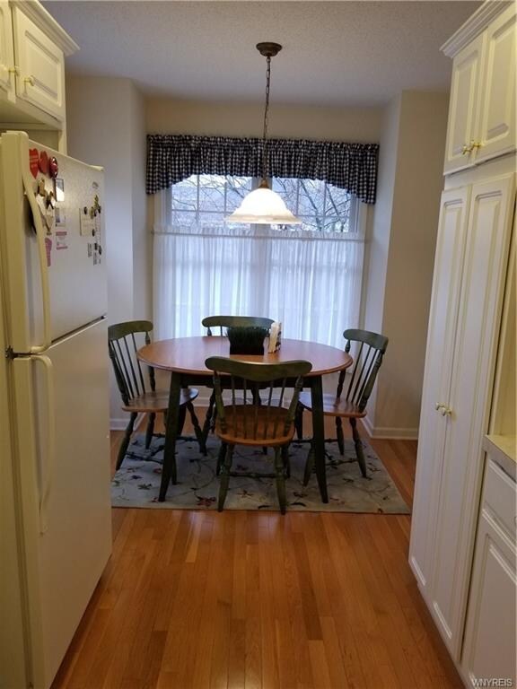 Eat in kitchen with gleaming hardwood floors