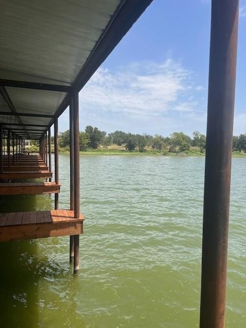 Dock area featuring a water view