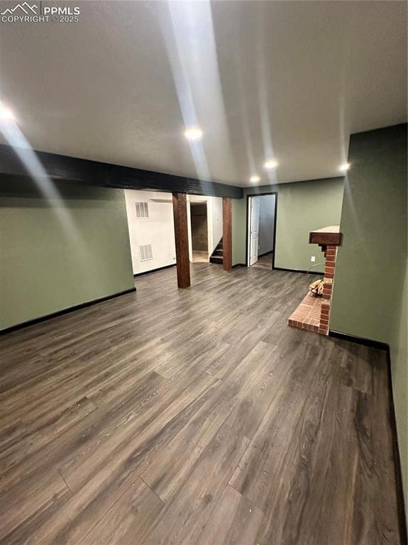 Finished below grade area with stairway and wood finished floors