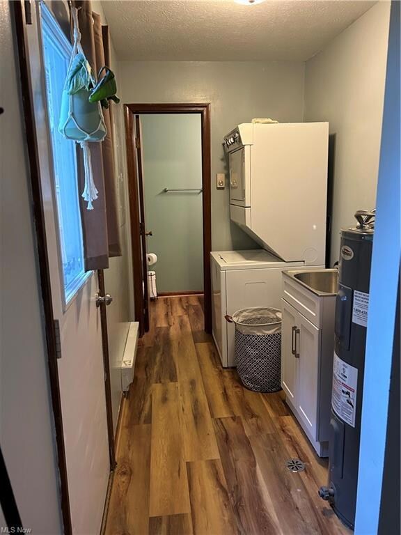 Laundry room with dark hardwood flooring, water he
