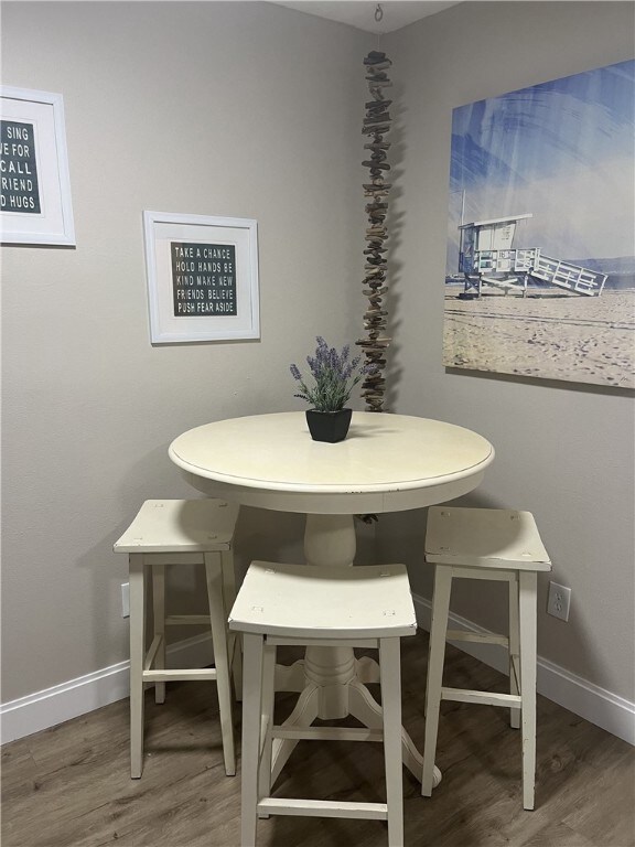 Dining room with baseboards and light wood-type flooring