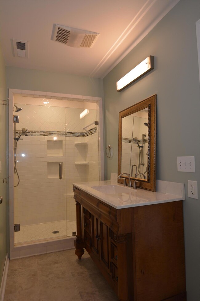 The master bedroom has a beautiful tiled shower. 