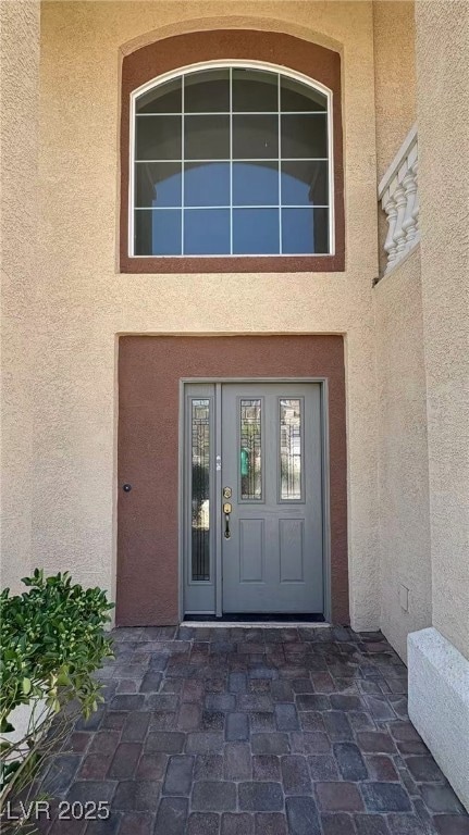 Doorway to property with stucco siding