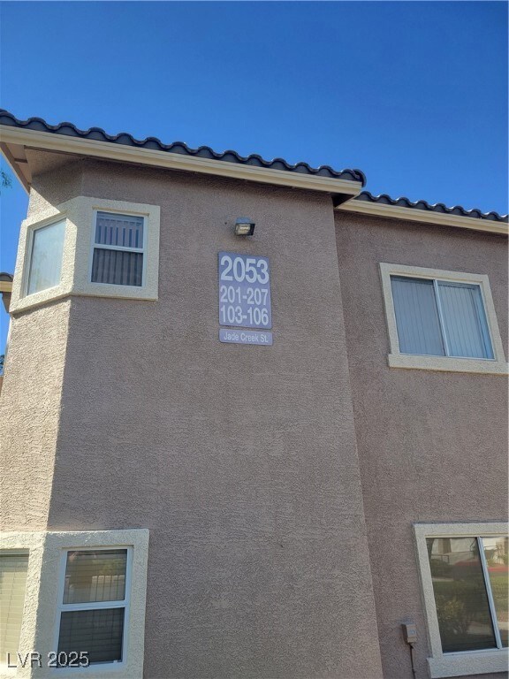 View of side of home with stucco siding