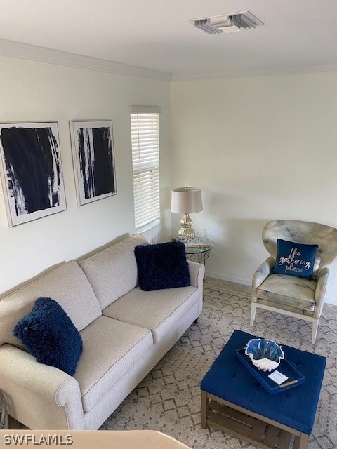 Carpeted living room featuring crown molding