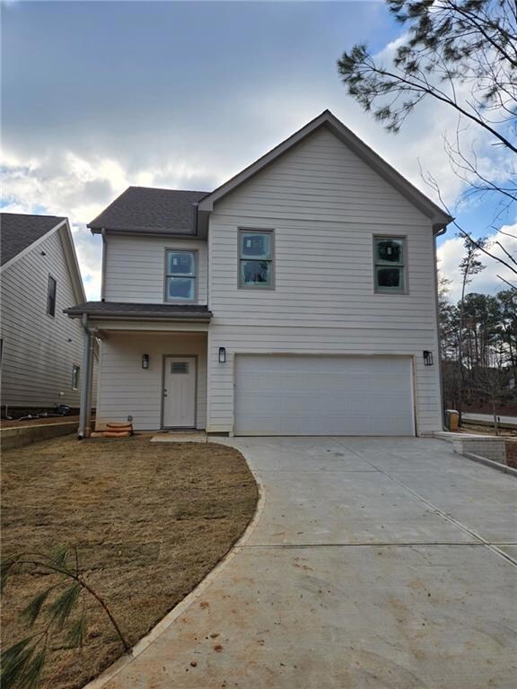 Traditional-style home with concrete driveway and 