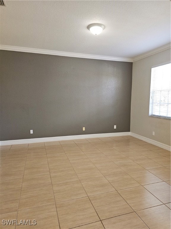Empty room with crown molding and a textured ceili