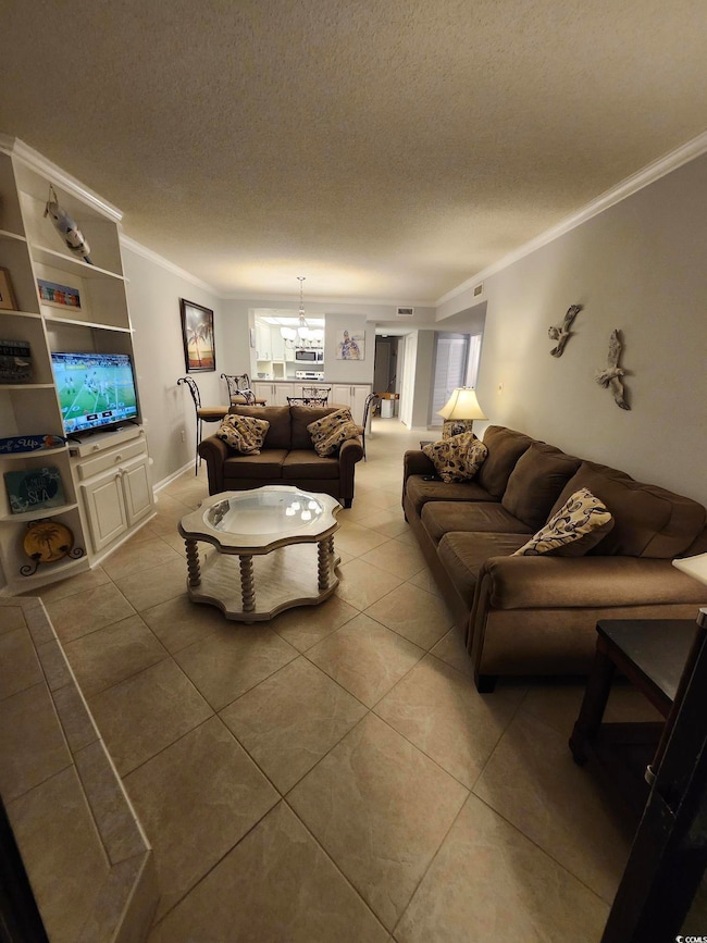 Living room featuring crown molding, a textured ce