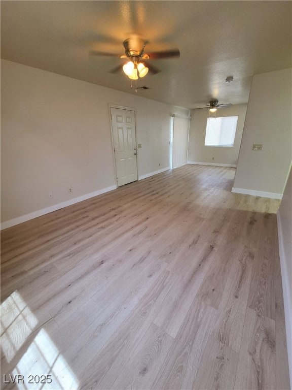 Unfurnished room with a ceiling fan and light wood