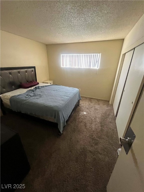 Bedroom featuring carpet floors, a textured ceilin