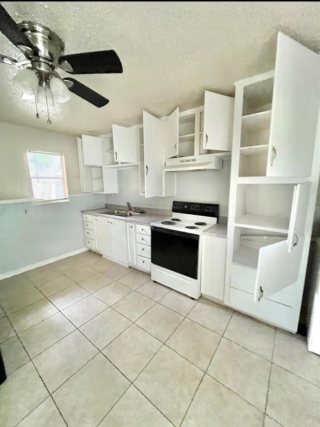 Kitchen with sink, light tile patterned floors, ve
