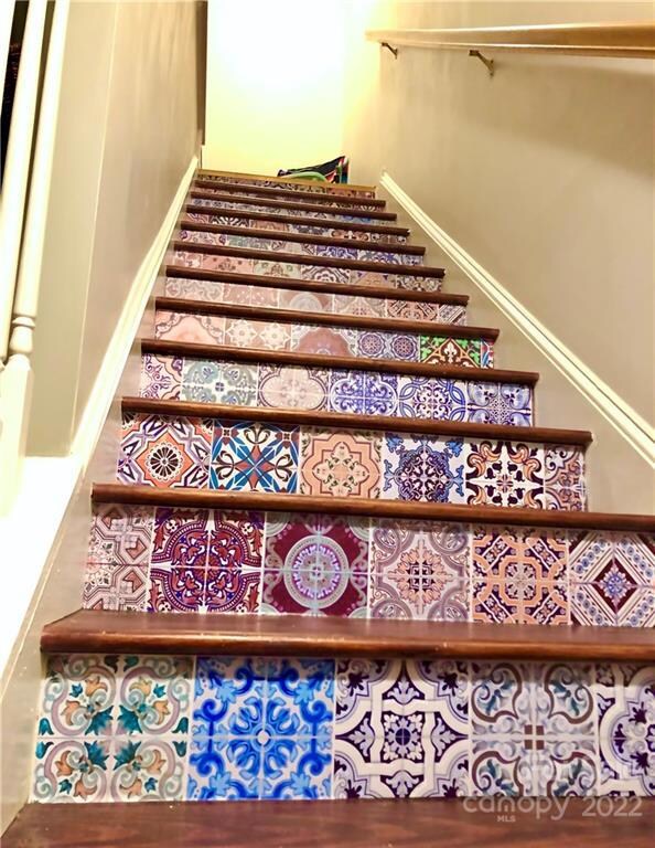 As you enter, beautiful mosaic tile accents the wood floors on stairs and throughout Townhome