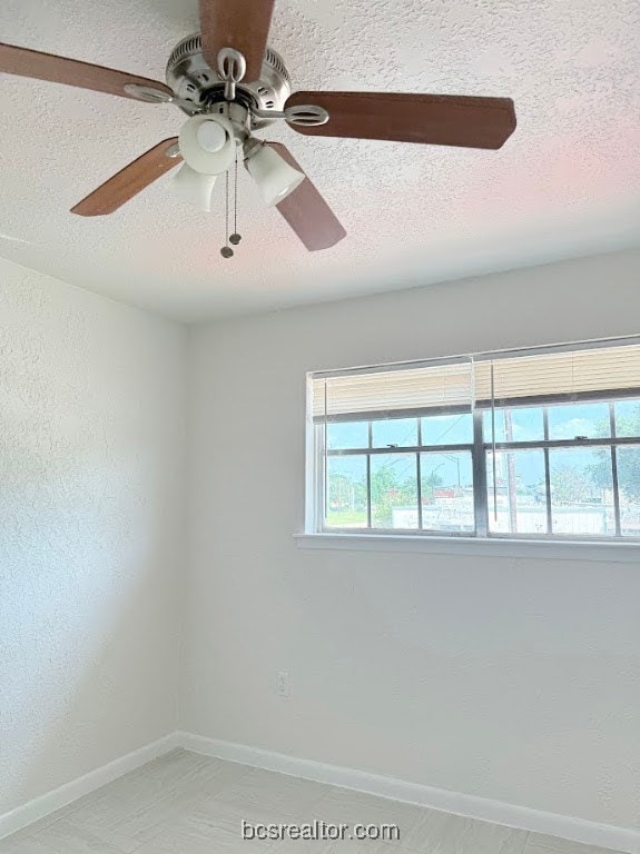 Spare room featuring a textured ceiling and ceiling fan