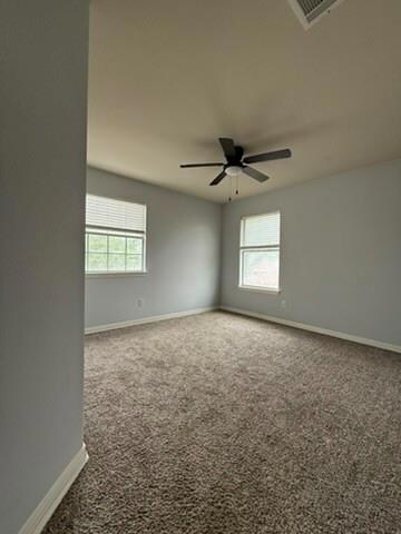 Carpeted empty room with a healthy amount of sunl