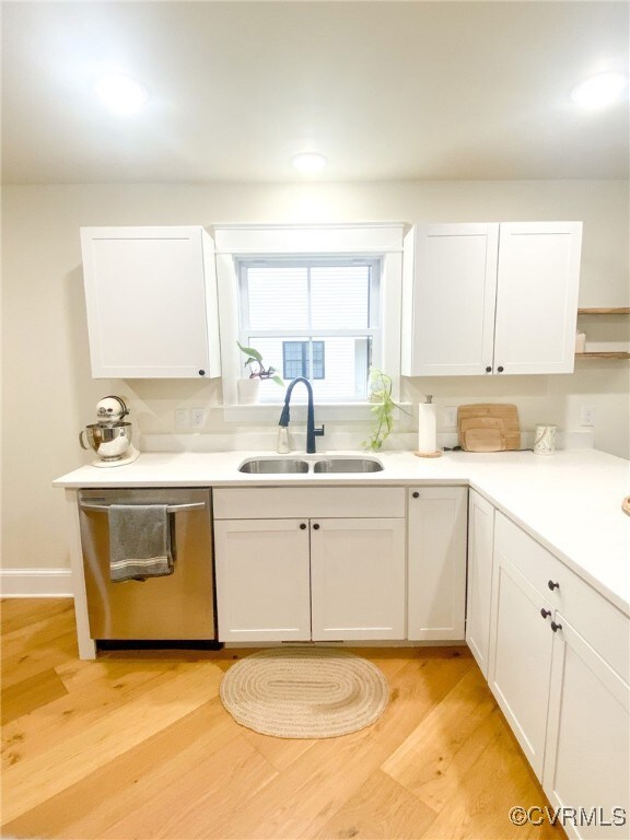 Kitchen featuring white cabinetry, a sink, and sta