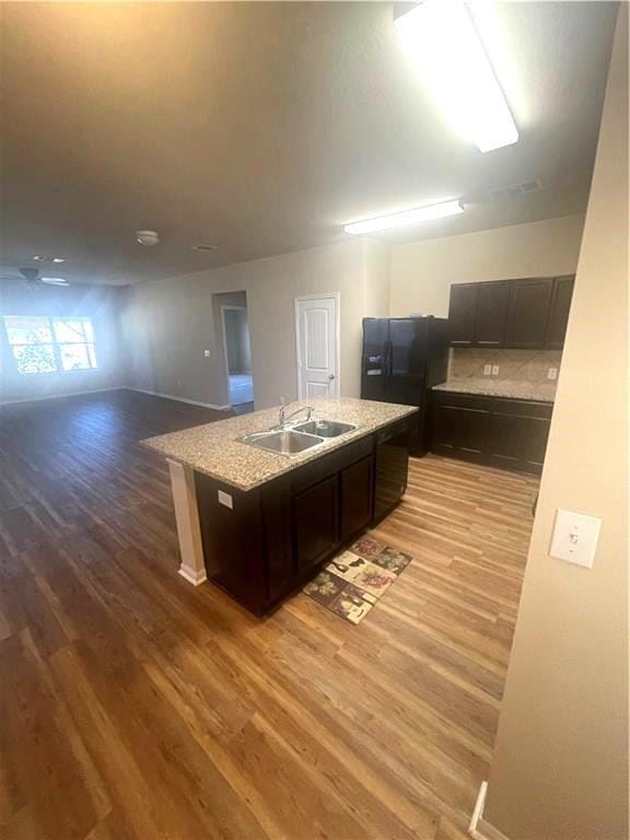 Kitchen with a sink, light wood-style flooring, a