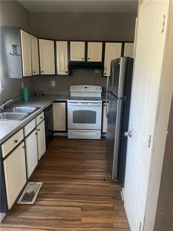 Kitchen with stainless steel fridge, white range w